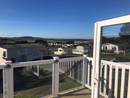 a balcony with a view of a neighborhood at Heavenly haven at Whitecliff Bay in Bembridge