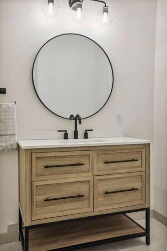 a bathroom sink with a mirror on top of it at Luxury Hastings Home, Sleeps 18+ in Hastings