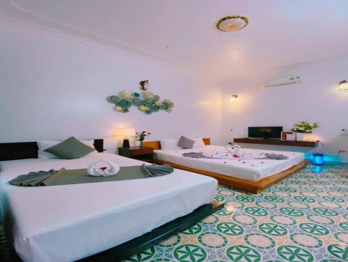 Habitación con 2 camas y sala de estar. en La Belle Vie Tam Coc Homestay, en Ninh Binh