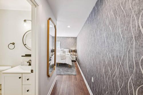 a bathroom with a gray wall with a mirror at Federal Hill Luxury + City Charm in Baltimore