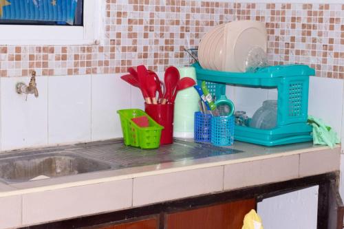 eine Küchentheke mit einer Spüle und Küchenutensilien in der Unterkunft elegant luxury 2 bedroom mombasa wifi two balconies in Mombasa
