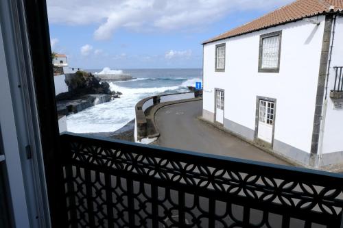 a view of the ocean from a window at Boa Nova Hostel in Santa Cruz da Graciosa