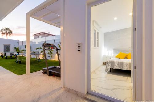a view of a bedroom with a bed and a patio at VILLA NICOLE wifi, gym, Heated Pool in Callao Salvaje