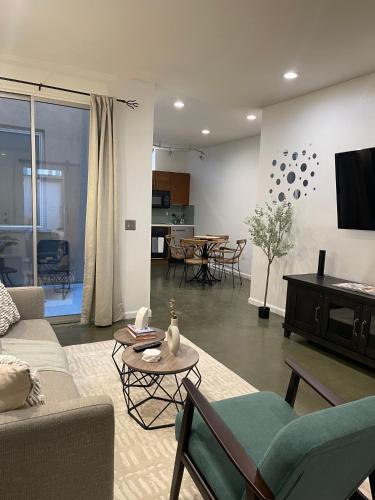 ein Wohnzimmer mit einem Sofa und einem Tisch in der Unterkunft Beautiful 2-Bedroom Apartment in the Heart of Little Italy in San Diego
