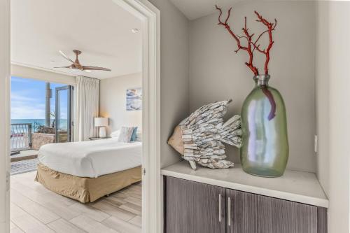 a bedroom with a bed and a vase on a cabinet at Oceanside Escape in Oceanside