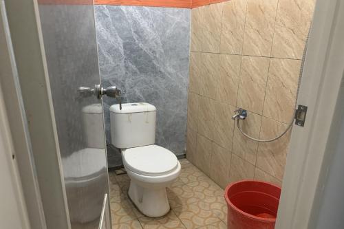 a small bathroom with a toilet in a stall at Mozza guest house in Klaten
