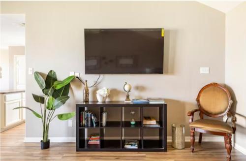a living room with a flat screen tv on a wall at 4BR Near Galveston, Kemah NASA, Recently Rehabbed in La Marque
