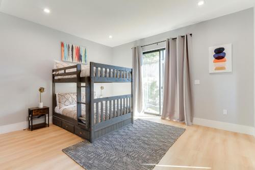 a childs bedroom with a crib and a large window at Brand New 9 Modern Bedroom Compound in Pickfair Village in Los Angeles