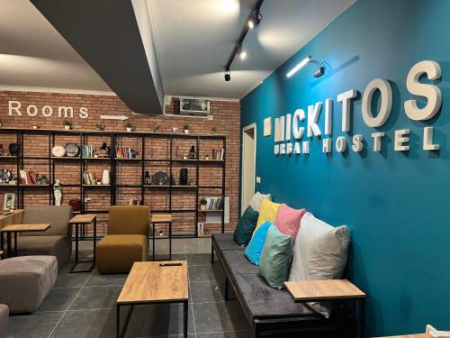 a waiting room with a couch and pillows on it at Mickitos Urban Hostel in Skopje