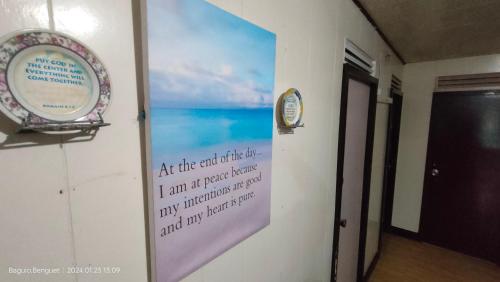 a sign on a wall with a picture of the ocean at Kochimoto Bed & Bath in Baguio
