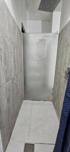 a shower stall with a door in a room at King bed Full apartment Private deck in Ponce