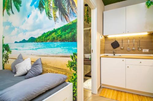 a kitchen with a beach mural on the wall at Tropical Holiday House in Catania