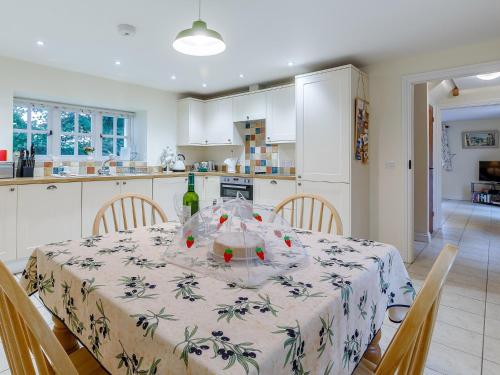 a kitchen with a table with a bottle of wine on it at 2 Bed in Truro LROSE 