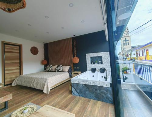 a bedroom with a bed and a bath tub at Habitacion Deluxe 2 con Jacuzzi a 20 mt del parque in Salento