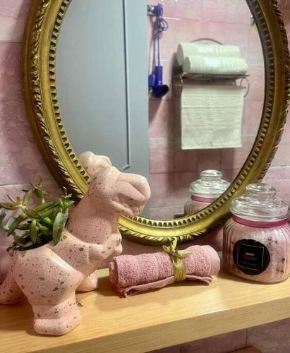 a stuffed rabbit sitting on a shelf in front of a mirror at Depto. Equipado, 1 Habitación con estacionamiento in Tulancingo
