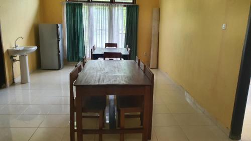 a dining room with a wooden table and chairs at Angel's Homestay Batutumonga in Rantepao