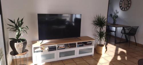 a flat screen tv sitting on top of a white entertainment center at El Cerrón in Llanes