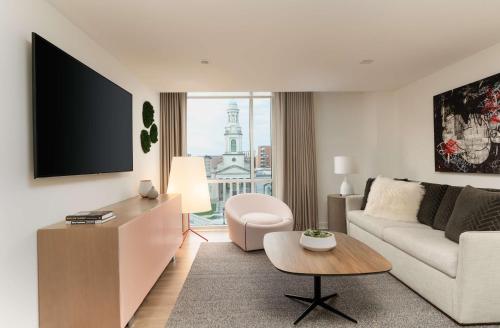 a living room with a couch and a table at Hotel Zena Washington DC in Washington