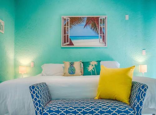 a blue bedroom with a bed and a chair at Great spot @ Marina, all Cabo's lifestyle on hand in Cabo San Lucas