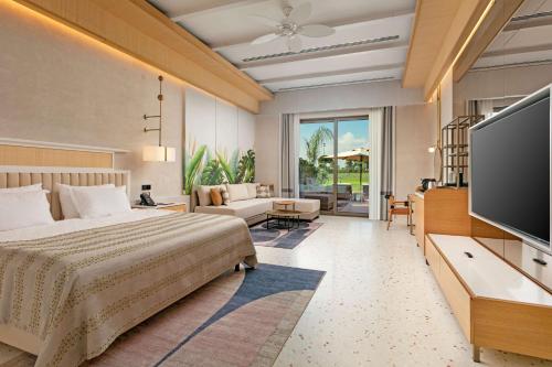 a bedroom with a bed and a flat screen tv at Cullinan Belek in Belek