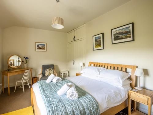 a bedroom with a bed and a desk with a chair at 2 Bed in Threlkeld SZ082 in Threlkeld