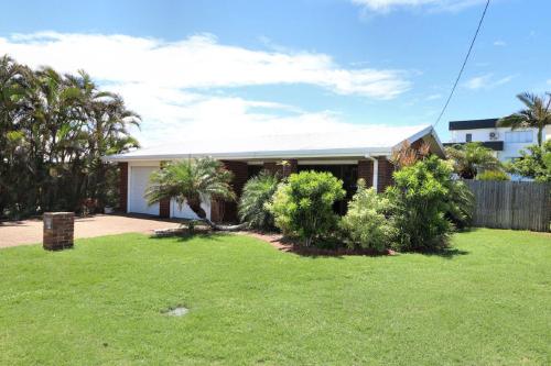 a house with a lawn in front of it at 12 Wilfred Street in Bargara