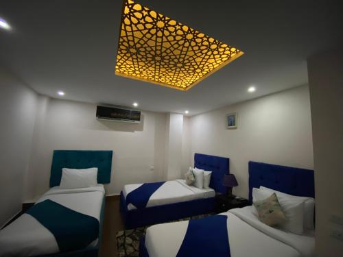 Ένα ή περισσότερα κρεβάτια σε δωμάτιο στο Golden Pyramids View Inn