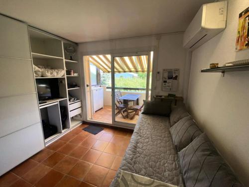 a small living room with a couch and a table at Résidence Jardins D Azur C - Studio pour 4 Personnes 024 in Six-Fours-les-Plages