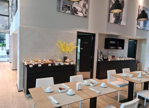 un restaurant avec des tables et des chaises et un buffet dans l'établissement Suíte Apart Hotel Mondial Salvador, à Salvador