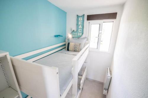 a small room with a bed and a window at SUNLIGHT HORIZON* Parking * Terrasse * Vue Mer * WIFI *Famille in La Grande Motte