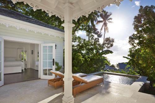 an outdoor patio with a view of the ocean at Sugar Beach, A Viceroy Resort in Soufrière