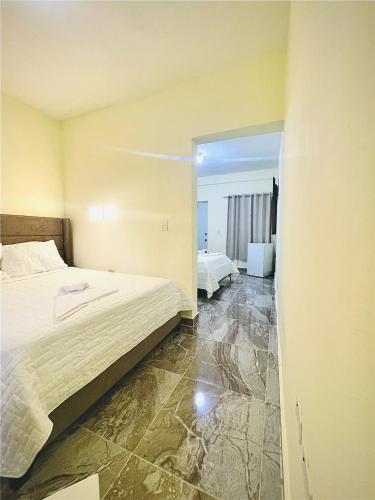a hotel room with a bed and a mirror at Neo’s hotel in Santa Cruz de Barahona