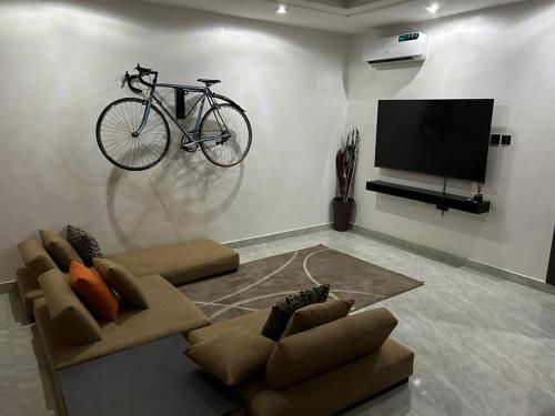a living room with a bike hanging on the wall at Humsidcy Hub in Lagos