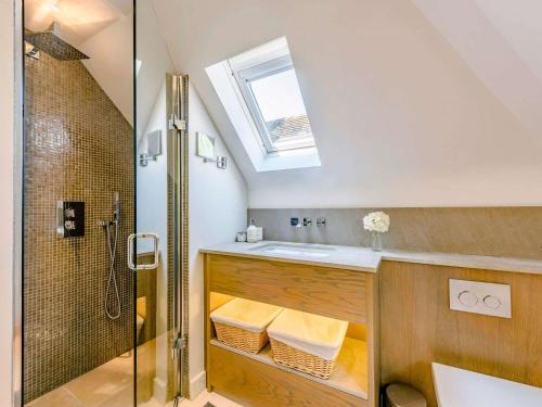 a bathroom with a sink and a shower at 5 Bed in Rye 82395 in Peasmarsh