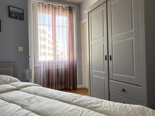 une chambre avec un lit et une grande fenêtre dans l'établissement Résidence Ondine - Charmant T2 de 34m² en plein cœur de la station balnéaire. MAE-2764, à Pléneuf-Val-André