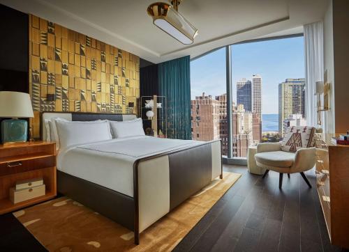 a bedroom with a bed and a large window at Viceroy Chicago in Chicago