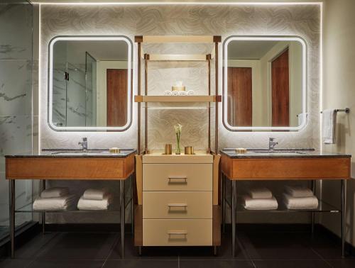 two sinks in a bathroom with two mirrors at Viceroy Chicago in Chicago