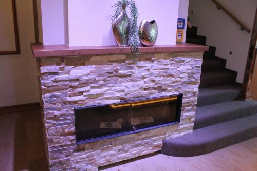 a stone fireplace with a fire place at Hotel-Restaurant Bierhäusle in Freiburg im Breisgau