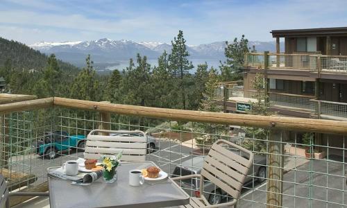 a table and chairs on a balcony with a view of mountains at Worldmark Lake Tahoe in Stateline