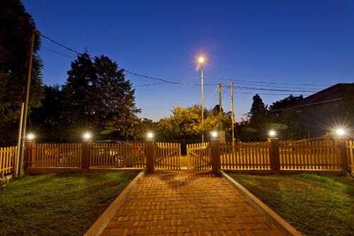 a wooden fence with lights on top of it at Orange Hotel in Gonio