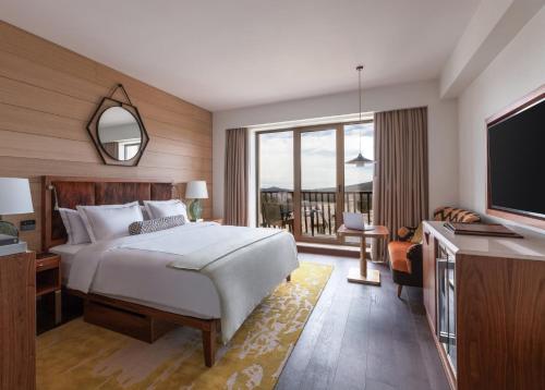 a hotel room with a bed and a television at Viceroy Kopaonik Serbia in Kopaonik