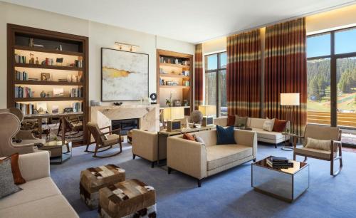 a living room filled with furniture and a fireplace at Viceroy Kopaonik Serbia in Kopaonik