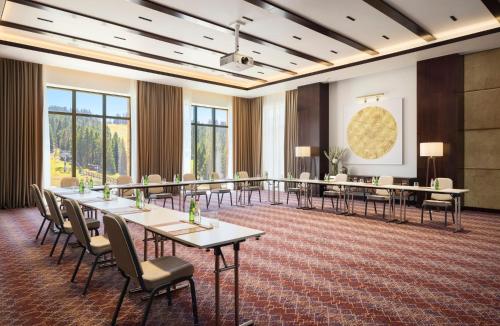 a conference room with long tables and chairs at Viceroy Kopaonik Serbia in Kopaonik