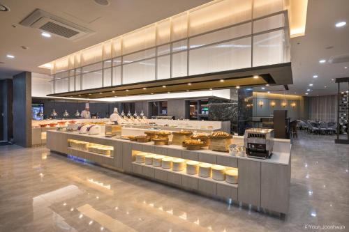 a bakery with a buffet of food on display at Grab The Ocean Songdo in Busan