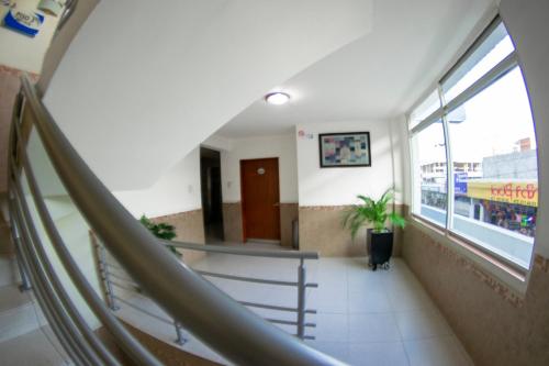 a hallway with a staircase in a building at Hotel Niza Zona Piel in León