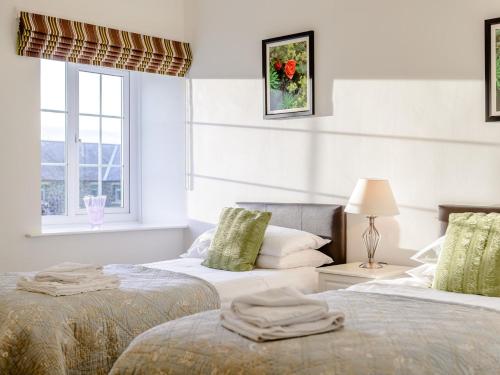 a bedroom with two beds and a window at 2 Bed in Newton-by-the-Sea 80482 in Newton-by-the-Sea