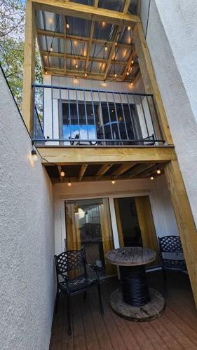 a balcony with a table and a wooden table at Fully Furnished Vicksburg Home Sleeps 10 in Vicksburg