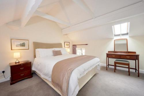 a white bedroom with a large bed and a table at 2 Bed in Buttermere SZ588 in Buttermere
