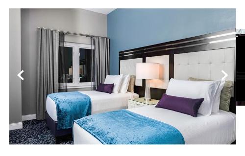 two beds in a hotel room with purple accents at Worldmark in Anaheim