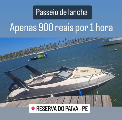 a boat is docked at a dock in the water at Bugan Paiva flatpaivahome in Recife